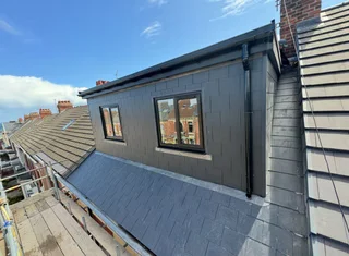 Modern dormer loft conversion with dark grey cladding
